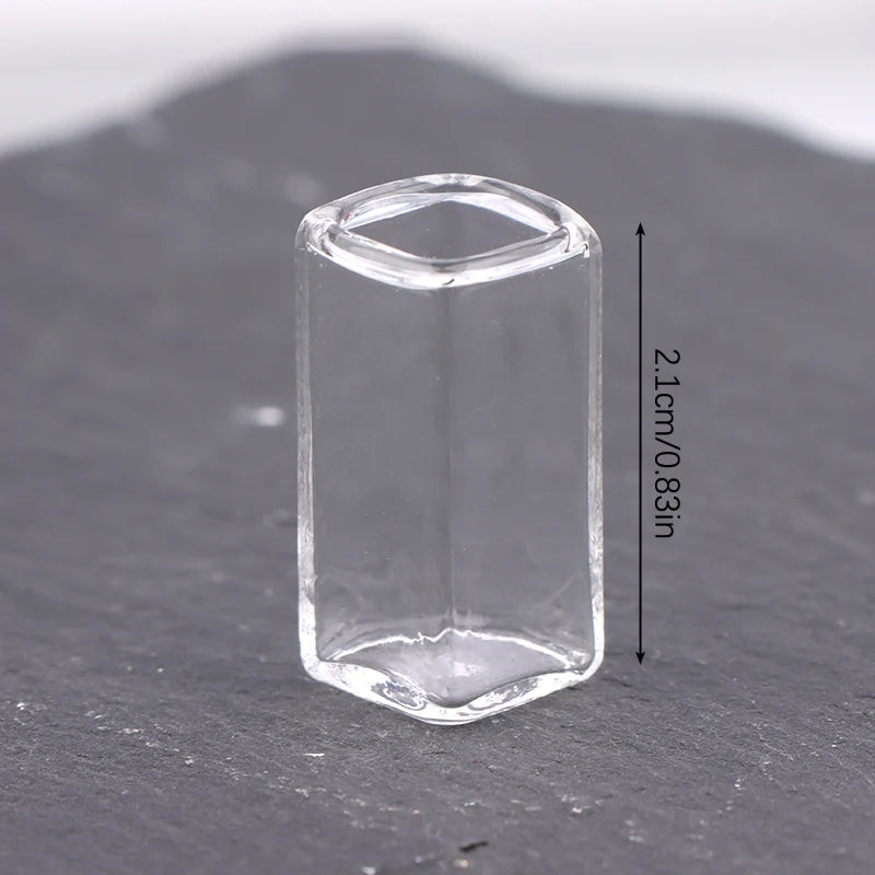 A clear glass vase or bottle with a cylindrical shape, measuring 2.1 cm (0.83 in).