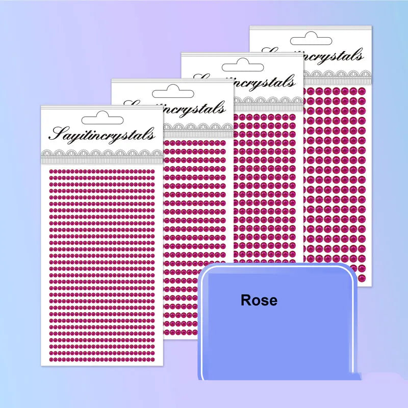A collection of pink and red rhinestone embellishment packs in various sizes and patterns.