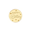 A round gold acrylic cake topper with the words HAPPY Birthday written in elegant script and small hearts.