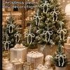 Elegant pearl bow decorations and ornaments adorning a festive Christmas tree.