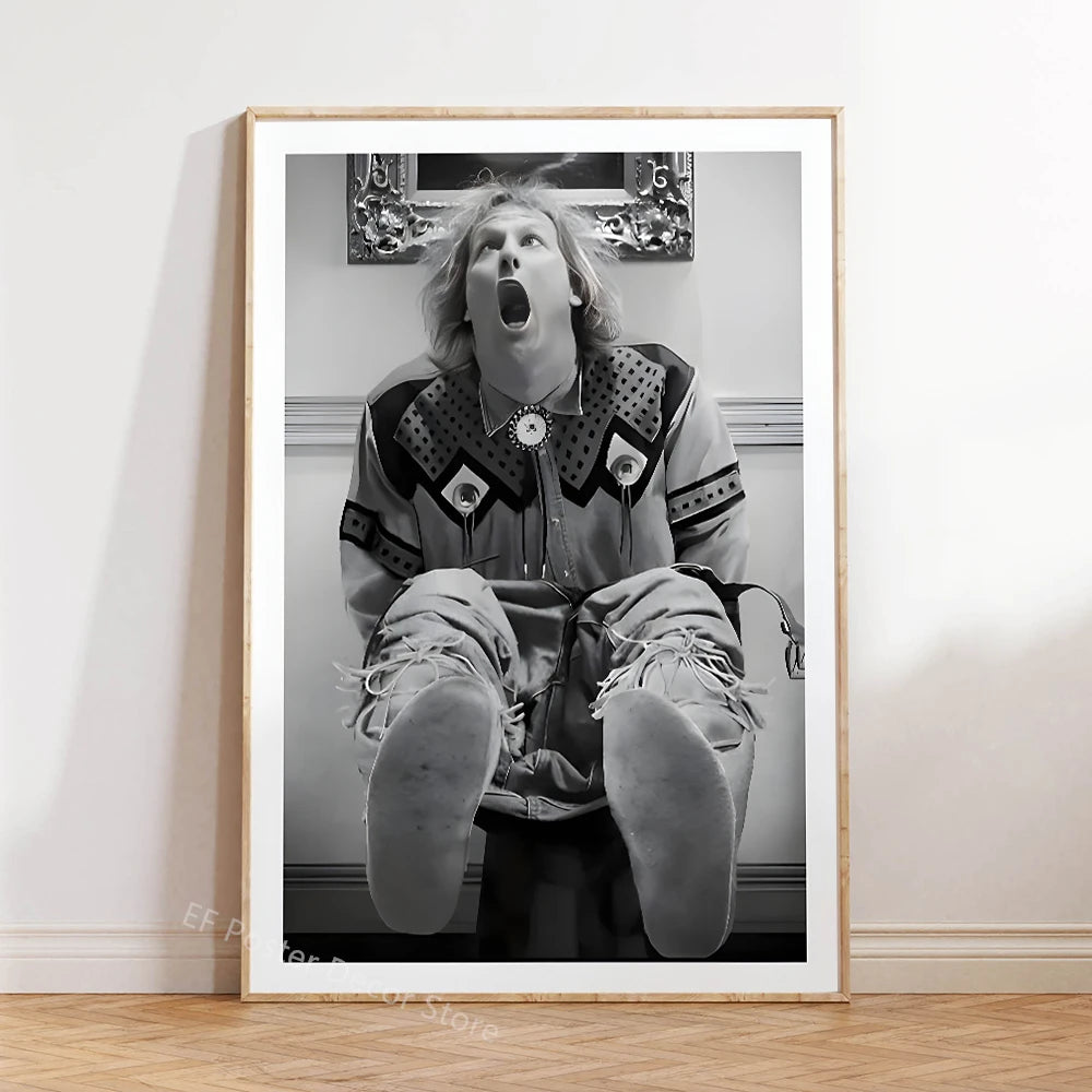 A framed black and white photograph of a person with long hair opening their mouth in surprise or shock.