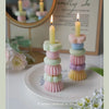 A set of handcrafted soy wax aromatherapy candles in pastel colors displayed on a white plate.