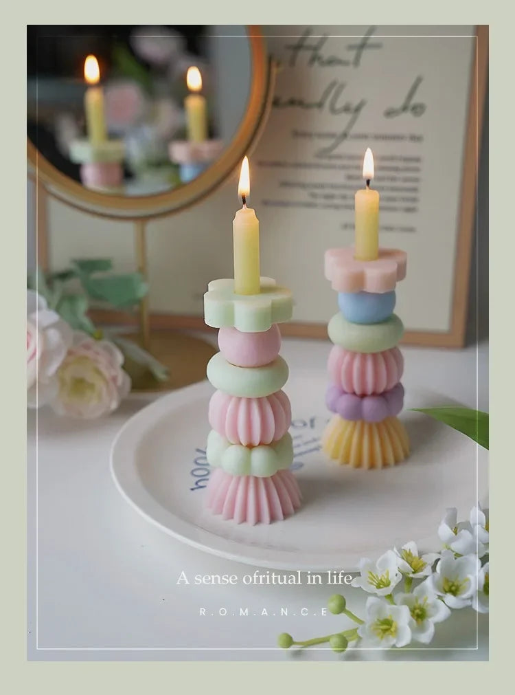 A set of handcrafted soy wax aromatherapy candles in pastel colors displayed on a white plate.