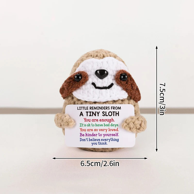 Handmade crochet potato doll with brown and white fur featuring an inspirational message on a tag