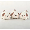 Three white and brown pig-shaped mochi squishy stress relief toys arranged side by side.