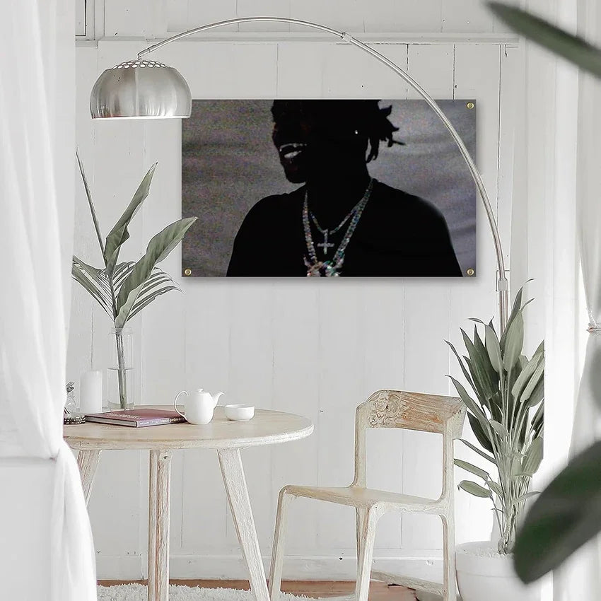 A large canvas tapestry featuring a silhouette of a person against a dark background, displayed on a wall.