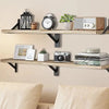 Natural wood floating wall shelves displaying clocks, framed photos, and decorative items.