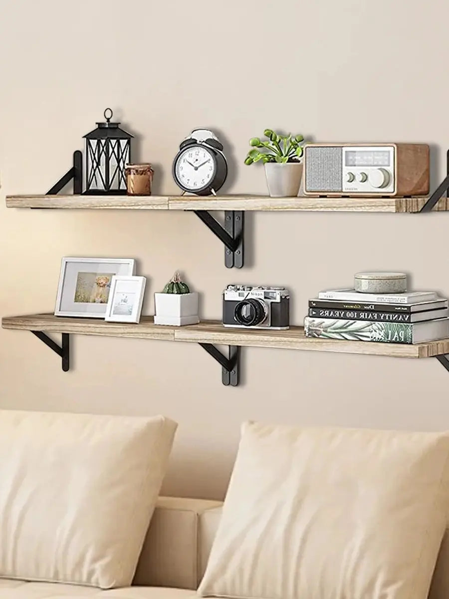 Natural wood floating wall shelves displaying clocks, framed photos, and decorative items.