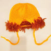 An orange handcrafted lion crochet outfit set for baby photo shoots featuring a knitted hat and dangling lion ears.