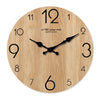 Round wooden wall clock face with black hands and numbers, featuring a wood grain texture.