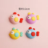 A set of five colorful ocean animal cake toppers including a pink crab, purple turtle, yellow starfish, blue whale, and orang
