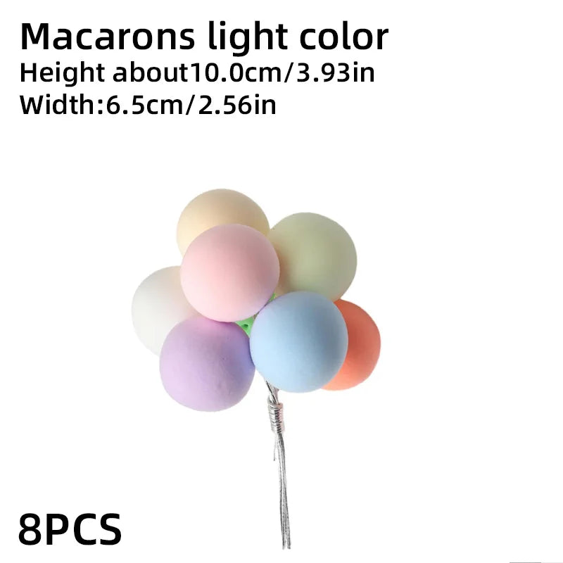 Eight light colored macarons in various pastel shades arranged on a stick.