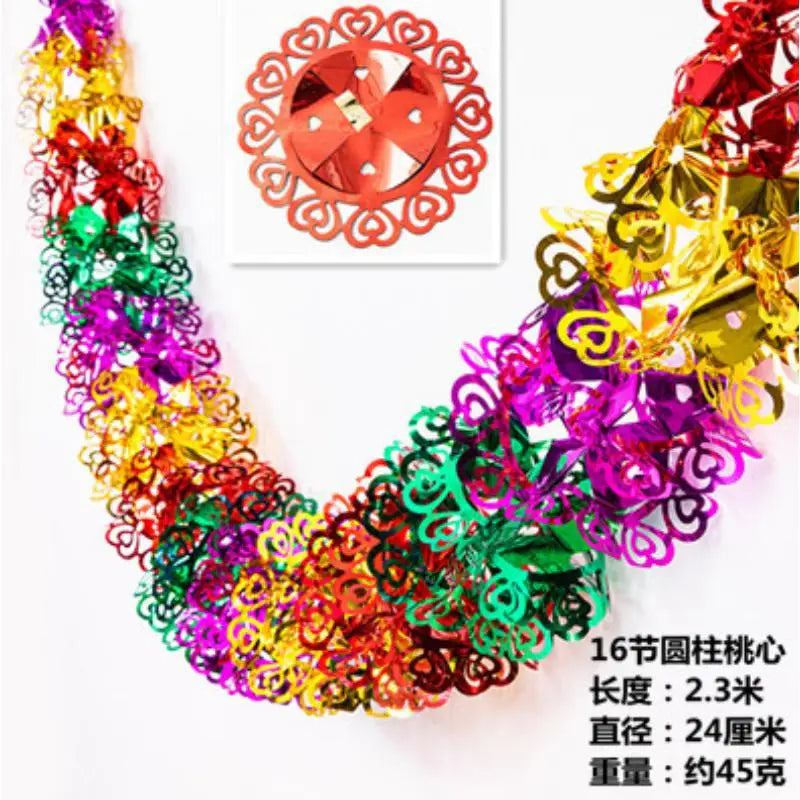 A vibrant, multi-colored tinsel garland ribbon featuring various metallic and iridescent colors for holiday decoration.