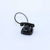 A black vintage rotary desk phone miniature decor with a coiled cord.
