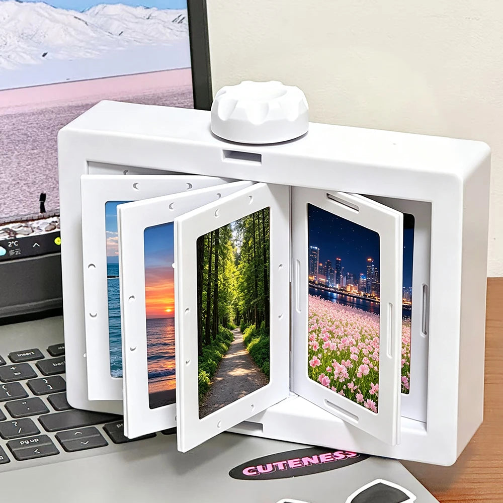 A white rotating flip photocard display frame is shown open on a laptop, displaying nature and cityscape scenes.