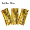 A bundle of gold wire ties used for sealing cellophane treat bags.