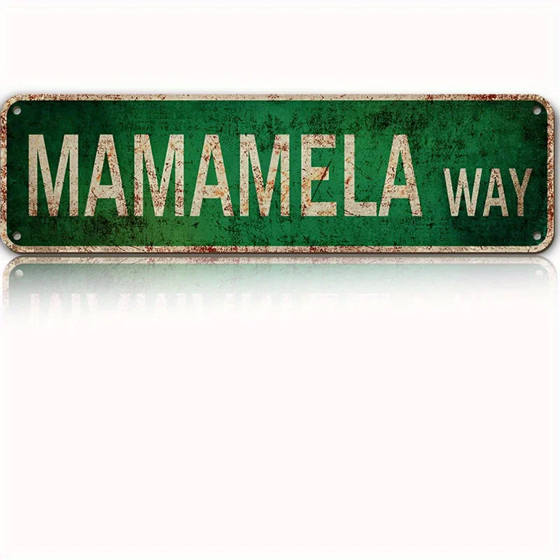 Vintage green metal tin sign with distressed lettering that reads MAMAMELA WAY