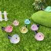A set of mini luminous resin bird fairy garden decor featuring various pastel colored birds on green moss.