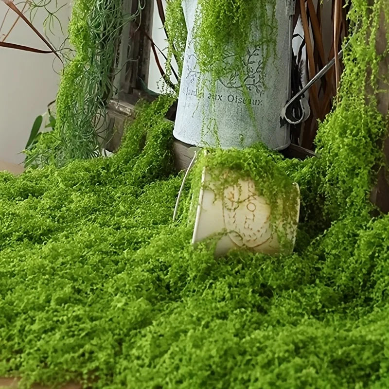 Artificial green moss covering a white object and surrounding foliage for home decor