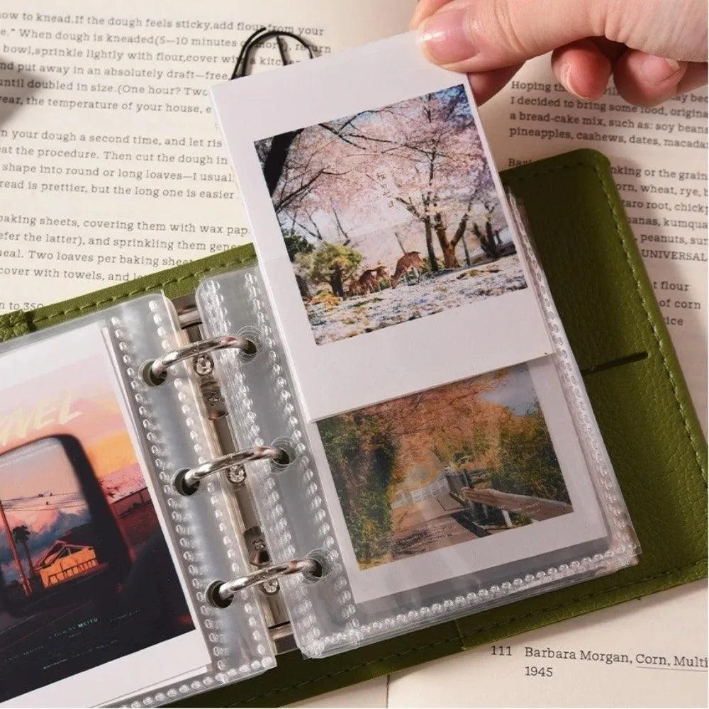 A close-up of a premium faux leather photo album with clear plastic sleeves displaying various photographs.
