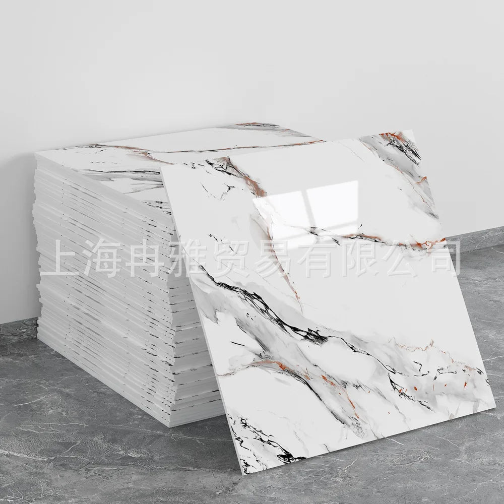 A stack of rectangular faux marble self-adhesive wall tiles featuring white and gray veining on a gray background.