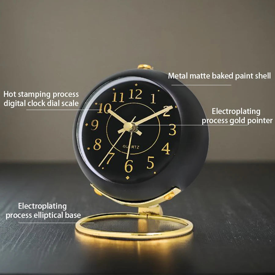 A black minimalist alarm clock with a gold-colored dial and an elliptical base, showing the time.
