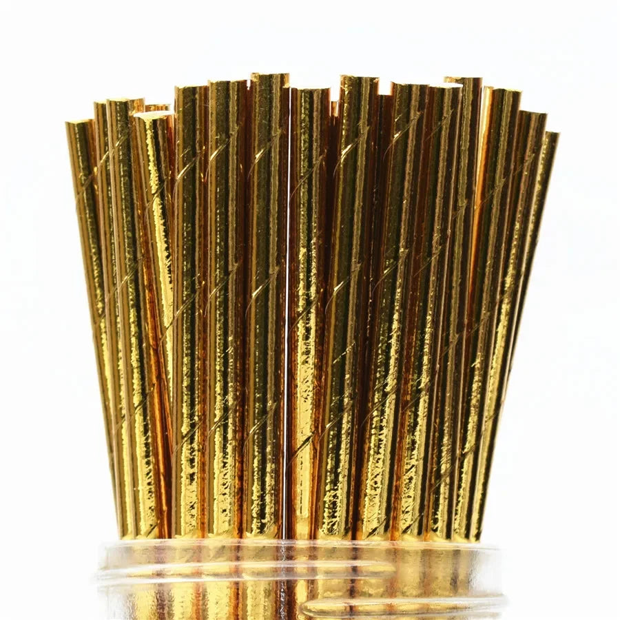 A close-up view of a pack of gold and bronze striped paper drinking straws.
