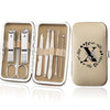 An open leather case displaying an 8-piece stainless steel manicure and pedicure kit with various tools.