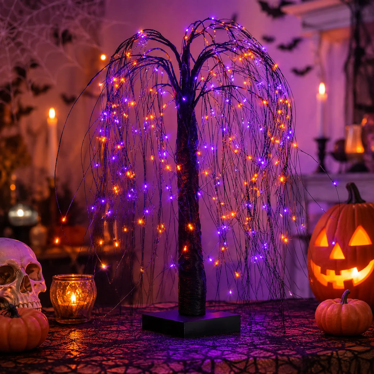 A Halloween light display featuring a tree silhouette made of purple and orange LEDs on a table.