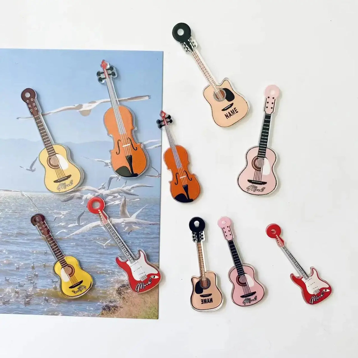A set of five guitar-shaped fridge magnets in various colors and finishes.