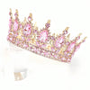 A pink crystal rhinestone crown featuring large pink stones and gold setting.