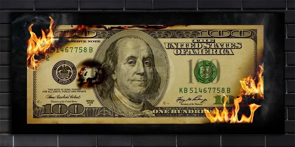 A 100 dollar bill is engulfed in flames against a dark background.