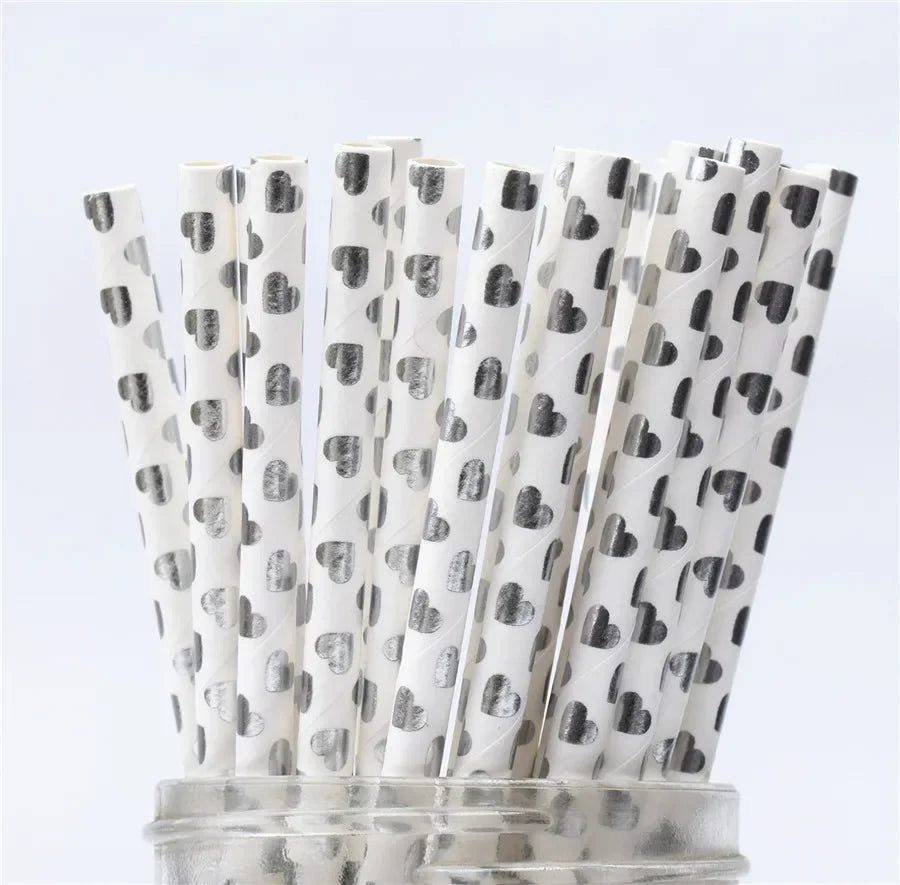 A pack of white drinking straws decorated with a pattern of gray hearts and polka dots.