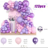 A purple and pink balloon garland featuring various sized balloons and a gold stand.