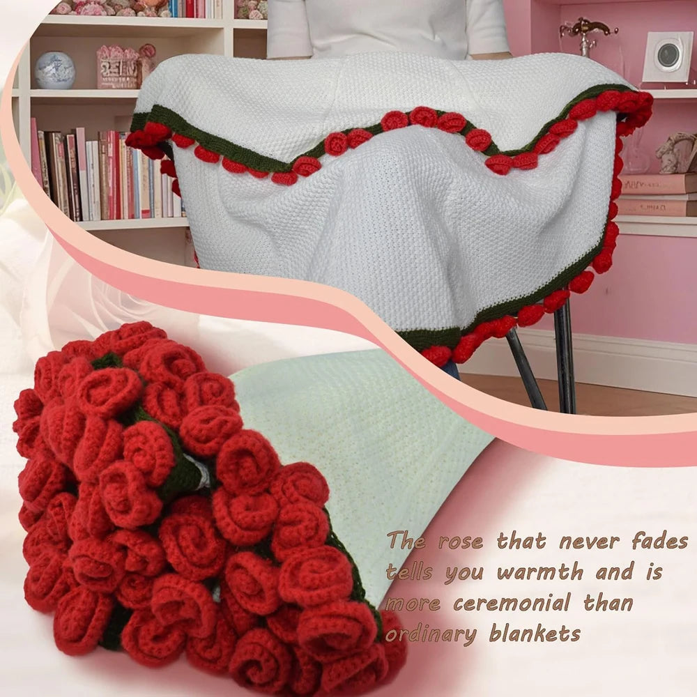 A handmade rose bouquet blanket gift featuring deep red roses and green accents displayed on a white knitted fabric.