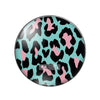A round glass cabochon with a black and pink leopard print pattern.