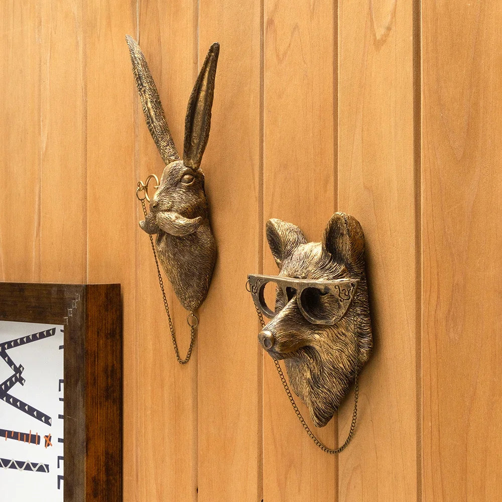 A bronze deer head storage hook wall decor mounted on a wooden panel.