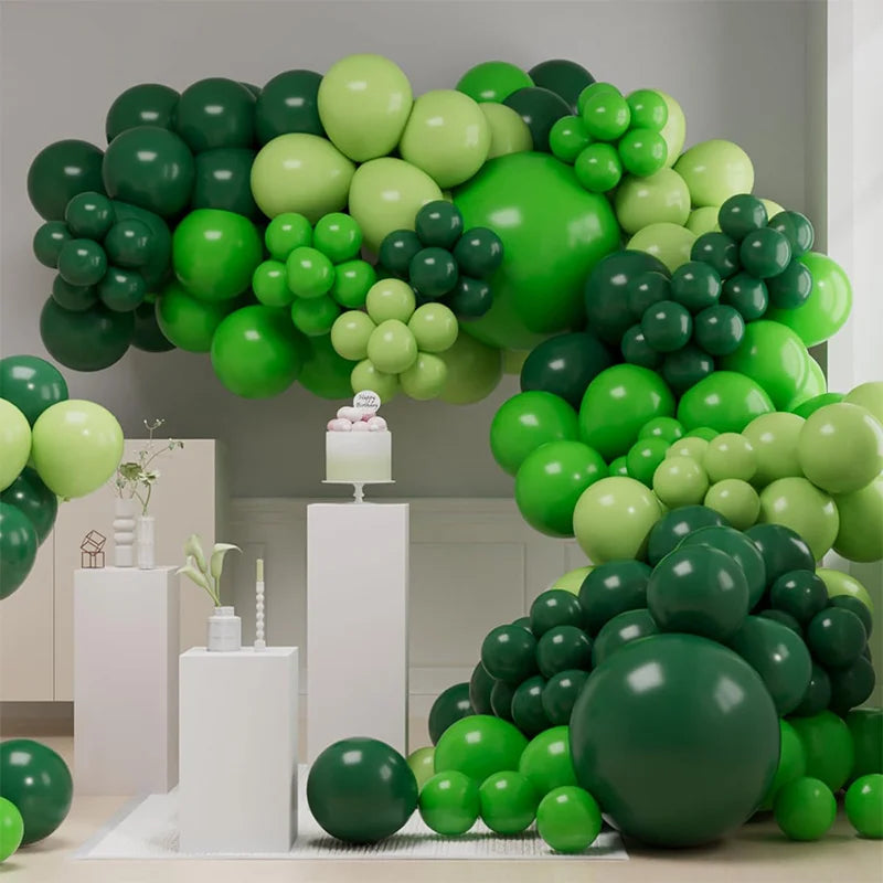 A lush green balloon garland arch kit featuring various shades of green balloons arranged for parties and events.