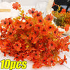 A bouquet of artificial silk flowers in vibrant orange and red hues.