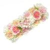 A lush floral arrangement featuring pink and cream artificial silk roses and hydrangeas for weddings and events.