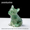 A translucent green crystal dog statue in a sitting pose used as a dropper for Feng Shui and decor