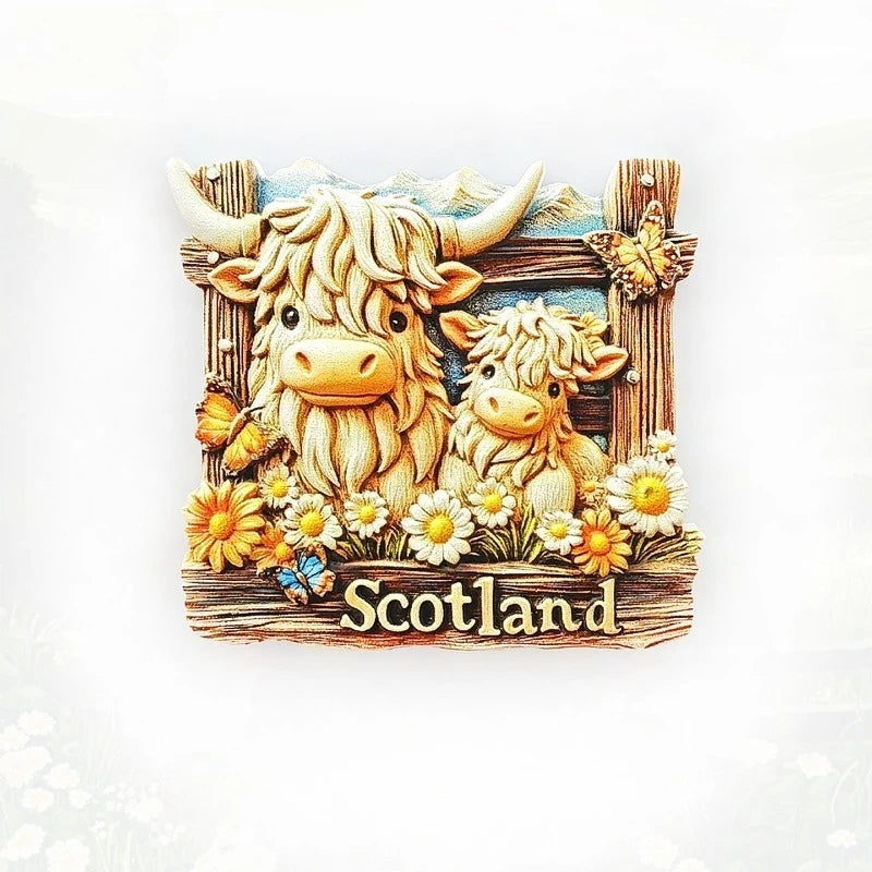 A wooden souvenir featuring two shaggy Highland cows and flowers with the word Scotland carved below.