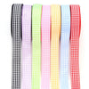 A collection of colorful gingham ribbon rolls in various patterns and colors for gift wrapping and decor.