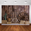 A rustic western backdrop featuring a wooden barn door, a cactus, and a large wooden wagon wheel.