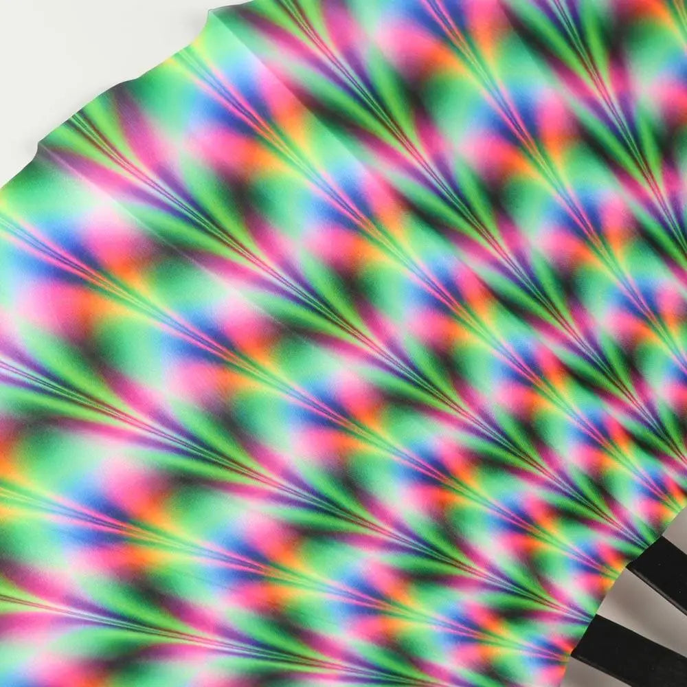 A close-up of a UV fluorescent handheld folding fan displaying vibrant rainbow colors and light patterns.