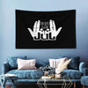 Black banner featuring white text 'FAIT LE JUL' with brass grommets displayed in a living room setting.
