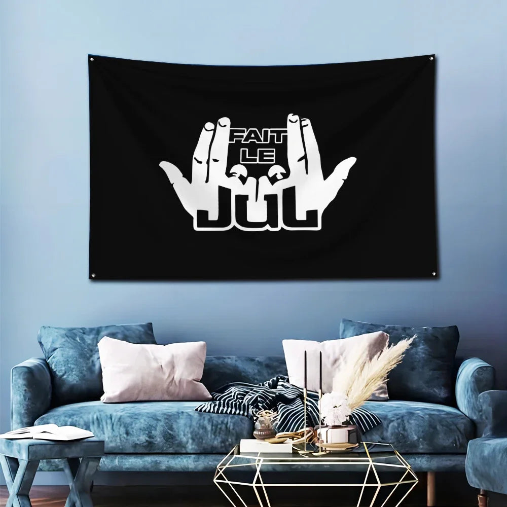 Black banner featuring white text 'FAIT LE JUL' with brass grommets displayed in a living room setting.