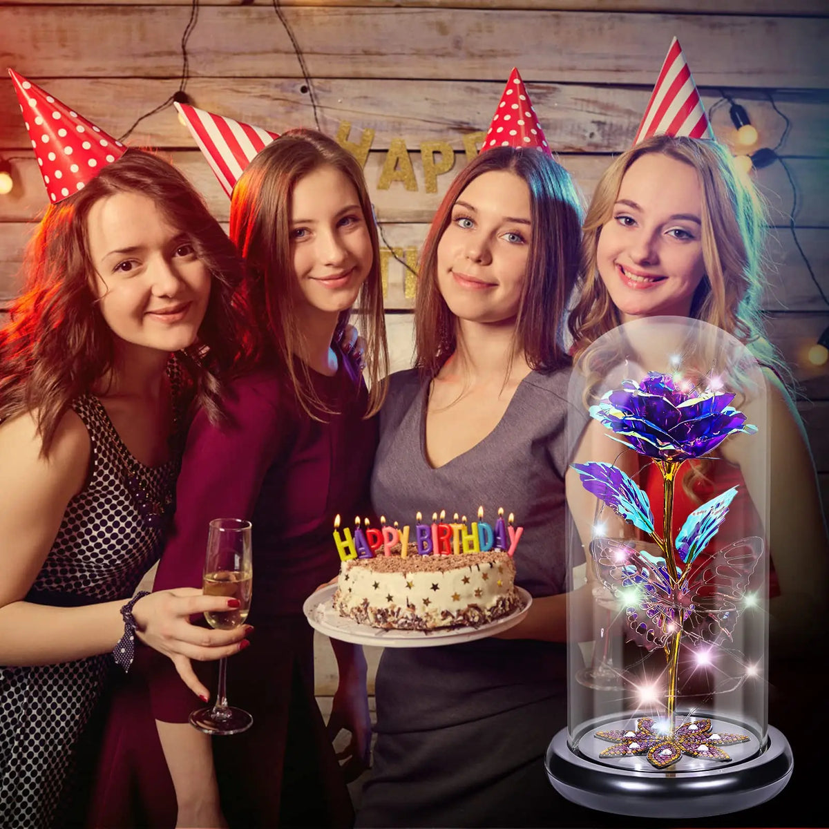 Four young women posing with a rose crystal flower in an illuminated glass dome
