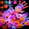 A collection of glowing Halloween-themed rings and accessories including pumpkins, skulls, and spooky figures.