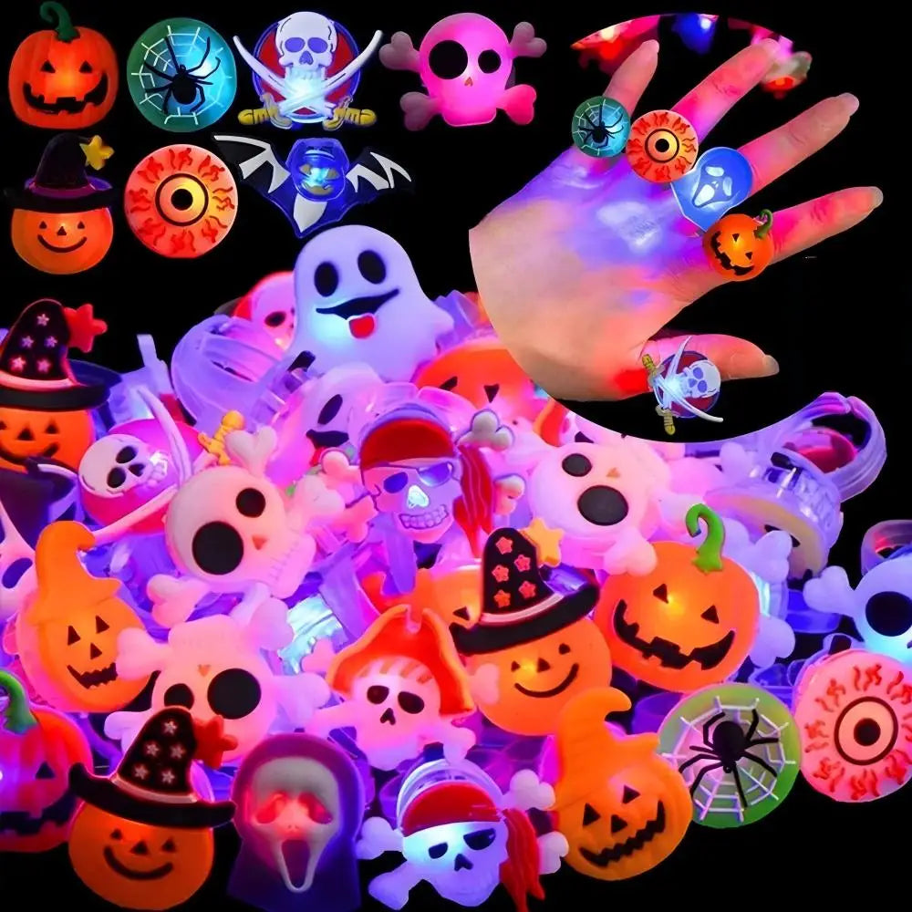 A collection of glowing Halloween-themed rings and accessories including pumpkins, skulls, and spooky figures.